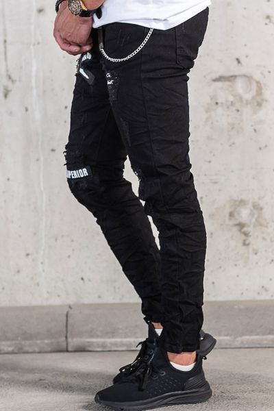 black streetwear jeans with text print, broken surface and chain