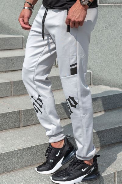 Gray jogger pants with a slippery surface and print